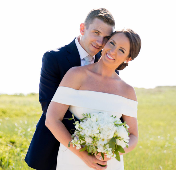 Married couple smiling during their portrait session at Bartlett Farms Nantucket