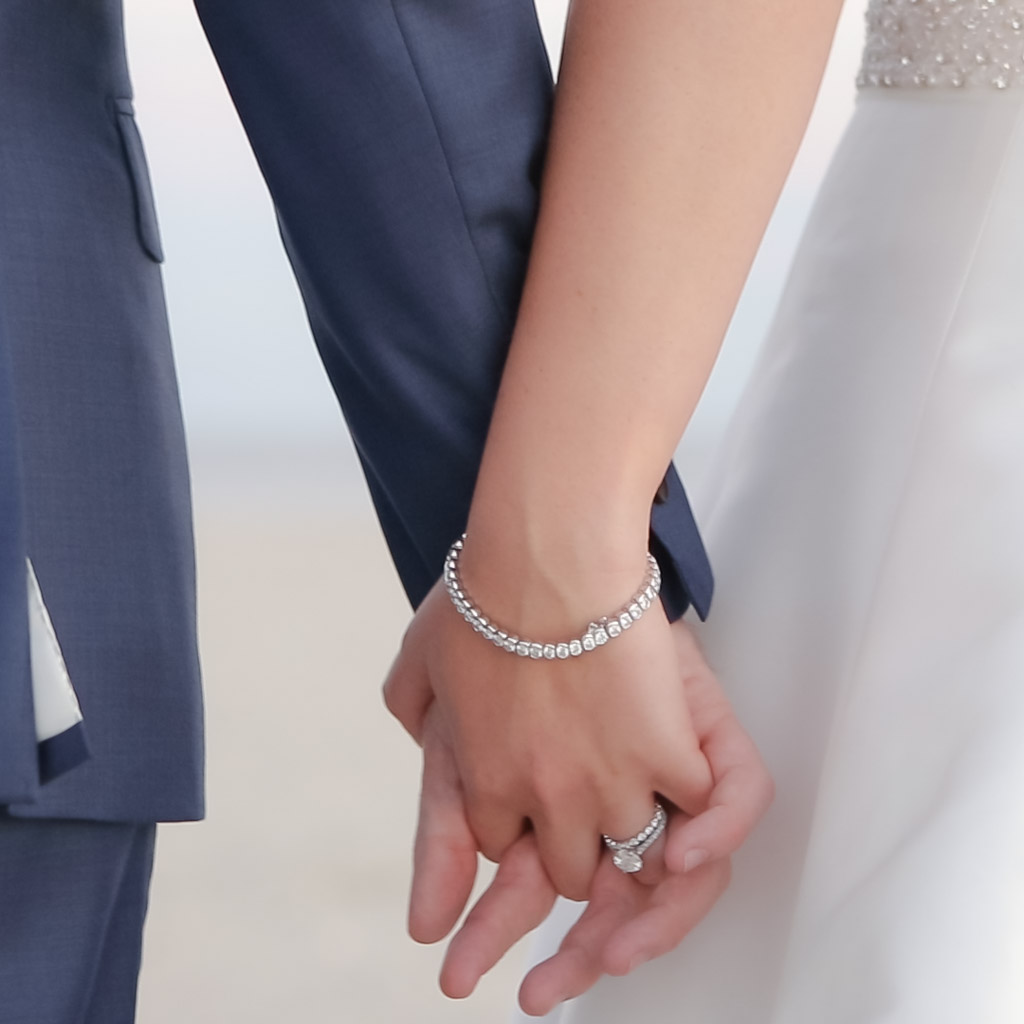 Wychmere wedding couple holding hands on the beach