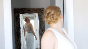 Wychmere Bride looking at her dress in a full length mirror