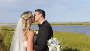 Martha's Vineyard wedding couple sharing a kiss by the water