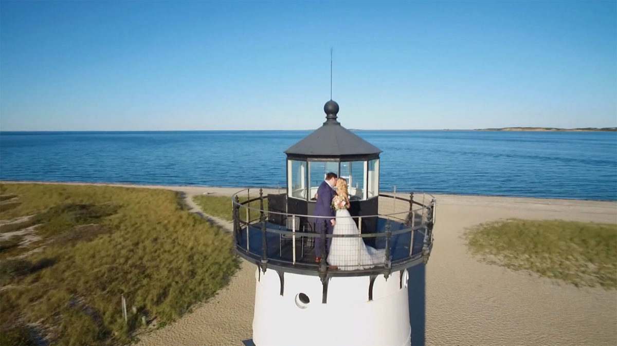 Bride and Groom kissing on top of Edgartown Lighthouse filmed by Harborview Studios