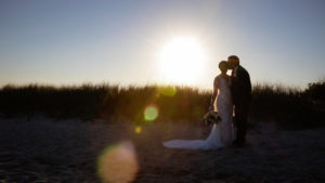 Wychmere wedding couple sharing a kiss the beach boardwalk