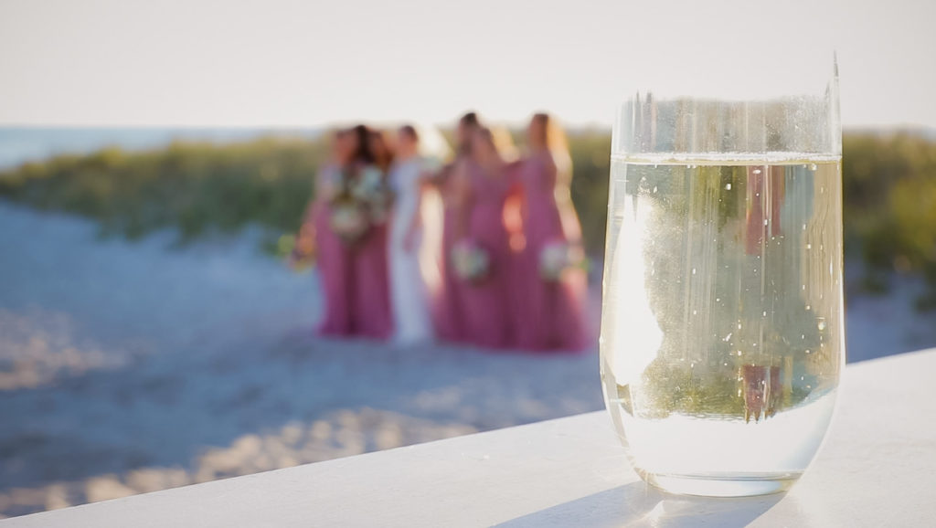 Glass of champagne with bridesmaids on the beach on Cape Cod