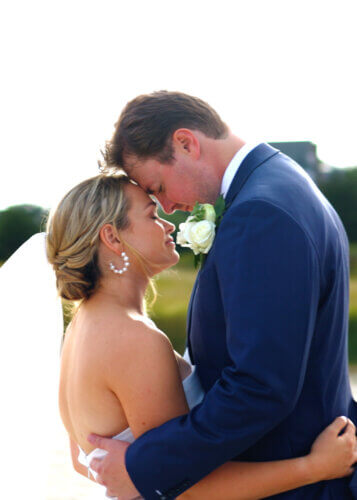 Home 3 Couple smiling on hyannisport beach during wedding film session
