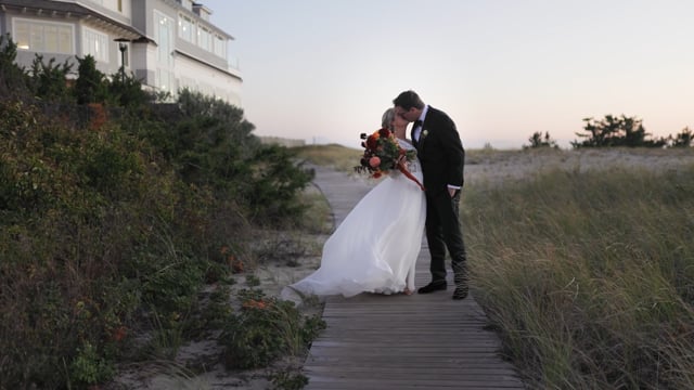 Bride and Groom kissing on boardwalk
